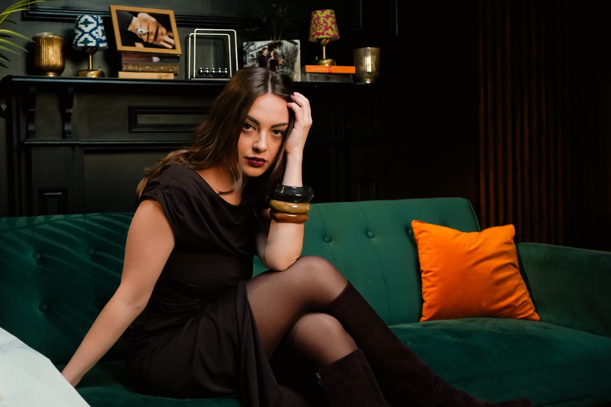 Hazel Rose sitting on a sofa in a quaint room